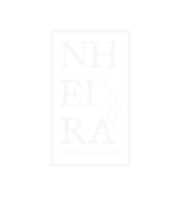 The site logo. It reads Nheira in all capitals with 'Nheira Ashford' written in the same font but a smaller size below. To the right, there is a swirly, wavy design that looks like kelp or seaweed. All of this is wrapped in a white rectangular border.'